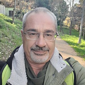 headshot of man with goatee wearing glasses